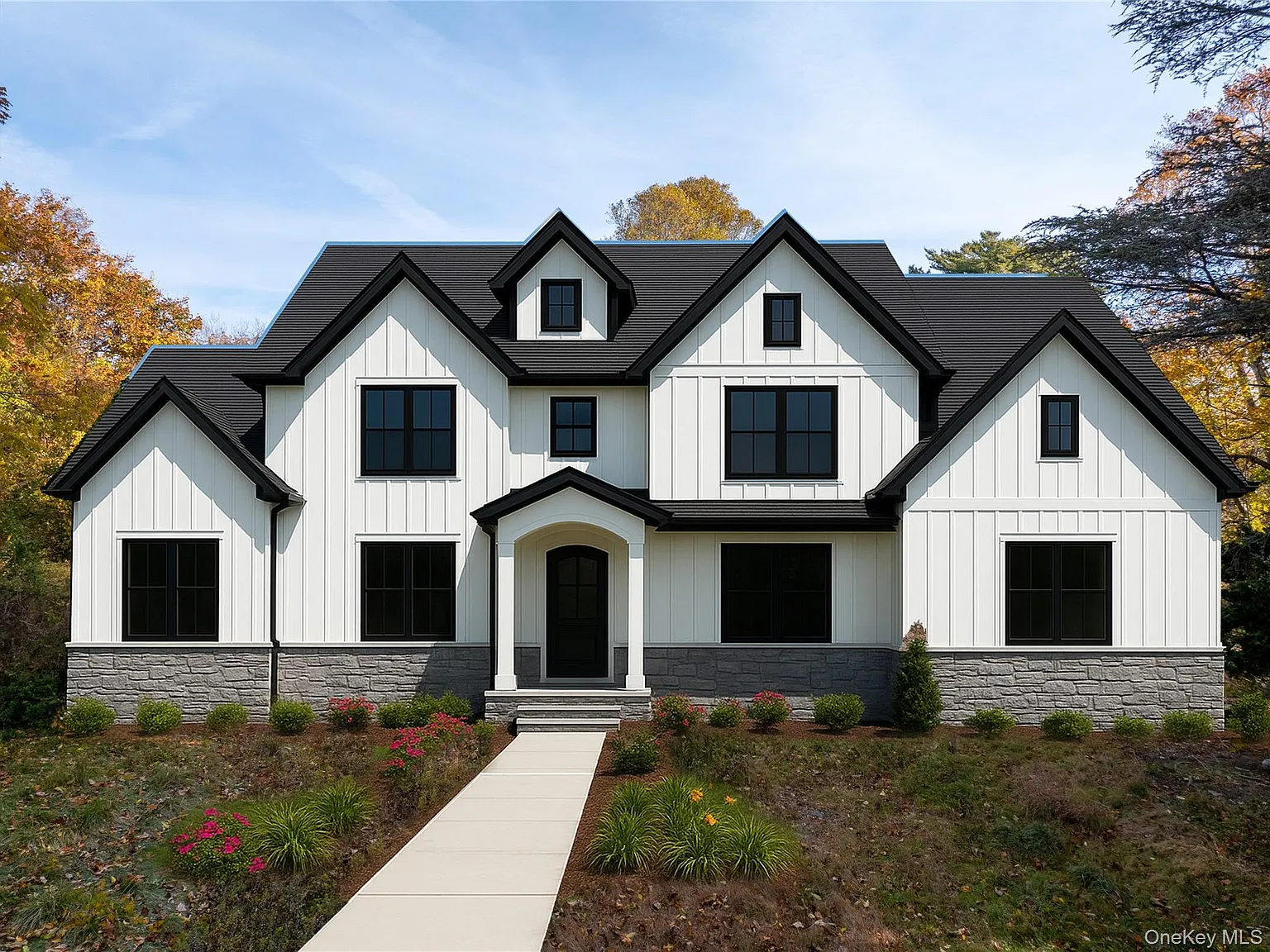 Finished exterior with board and batten siding and stone accents